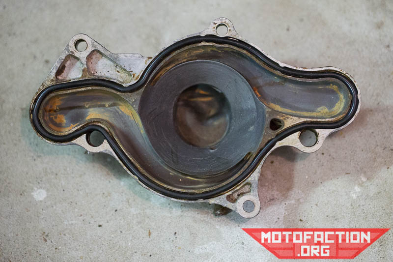 Here are some photos showing the reinstallation process for the water pump impeller cover on a Honda CX500, GL500, CX650 or GL650 motorcycle as shown on MotoFaction.org.